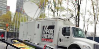 Fox News Parts Ways With Longtime Host Fox News microphone and satellite truck on city street