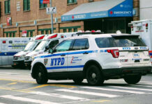 New York Disability Oversight Faces Scrutiny Police car and ambulances outside emergency room entrance.