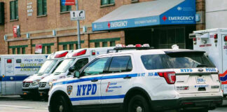 New York Disability Oversight Faces Scrutiny Police car and ambulances outside emergency room entrance.