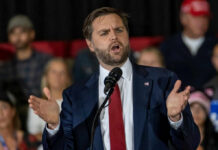 Viral Confrontation Fuels Free Speech Debate Man in suit speaking at a podium