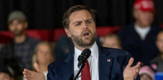 Viral Confrontation Fuels Free Speech Debate Man in suit speaking at a podium