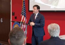 AI, Politics and a Viral Claim Speaker in a navy suit addressing an audience at a podium