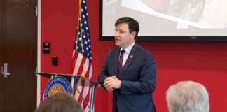 AI, Politics and a Viral Claim Speaker in a navy suit addressing an audience at a podium