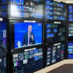 Two Nations Face Rising Security Challenges Vladimir Putin on multiple control room monitors