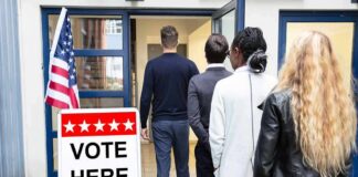 Socialism Debate Shapes Midterm Campaigns Voters standing in line at a polling place entrance