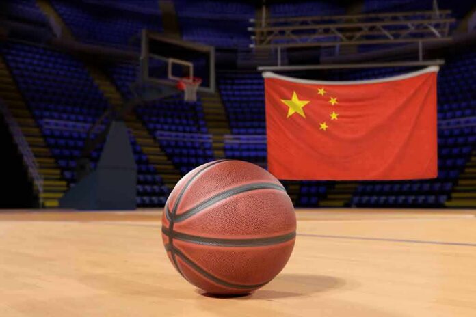 Basketball on an indoor court with a Chinese flag in the background