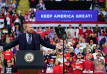 Trump’s “Take Out” Remarks Spark Outrage Crowd at a political rally with a speaker at a podium; Stephen Paea, Curtis Lofton, Walter Jones, John Sullivan, and Colin David Jones present