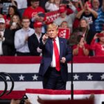 Kid Rock Takes Aim at Major News Outlets Donald Trump points from a rally stage; Rudi Koertzen and Bear Pascoe are in the crowd