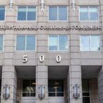 Federal Agents Search Congresswoman’s Home US government building facade with flags and number 500