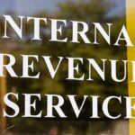 Internal Revenue Service sign on glass door
