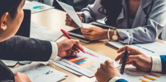 business team reviewing charts at a meeting table