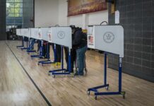 DOJ Targets Ballots Tied to Suspected Noncitizens Voters at polling booths in a gymnasium