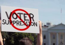 General Rules Out Troops at Polls Protester holding a sign in front of a government building