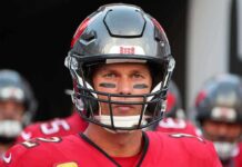 football player in helmet and red jersey looking forward