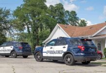 SUV Plunges Into Backyard Pool Two police SUVs parked near a suburban house