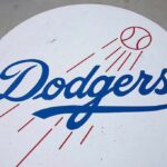 Brewers Take 2-0 NLCS Lead Over Dodgers Dodgers logo with baseball and motion lines