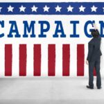 “Proof of Life” Demand Stirs Controversy Man in suit writing on large campaign banner with stars and stripes