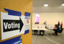Pollsters Warn of Response Gaps Voting sign on door leading to polling place