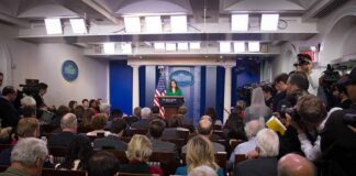 Transgender Care Policy Clash Deepens Press secretary at podium addressing reporters in briefing room